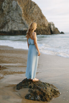 Young, Beautiful Blonde Woman Standing on Rock in Pacific Ocean