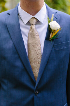 Groom Wearing Tie and Fly Fish Boutonniere