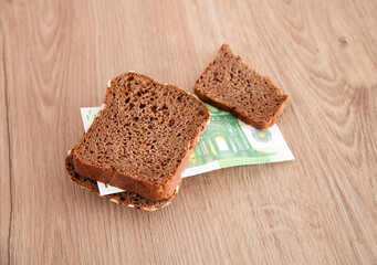 Black bread and euro banknote