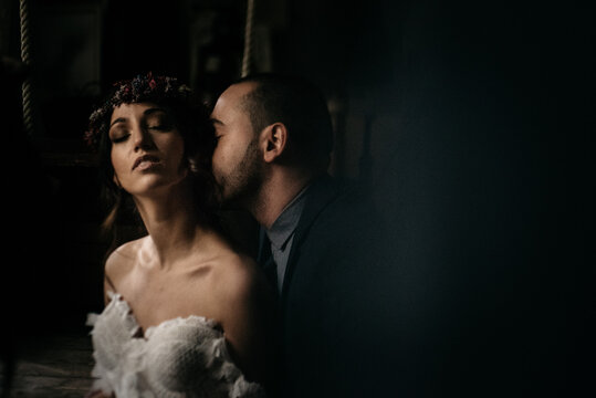 a groom kissing his bride on the neck