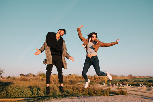 Couple jumping in a park