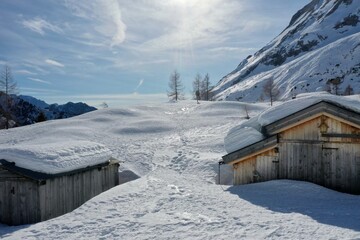 Fototapeta premium aerial snow covered mountain peaks in alps at winter 