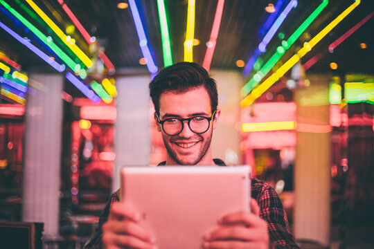 Smiling young man taking a selfie with his tablet