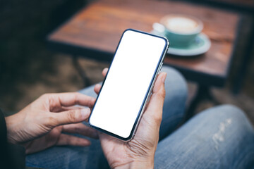cell phone mockup blank white screen.woman hand holding texting using mobile on desk at coffee shop.background empty space for advertise.work people contact marketing business,technology