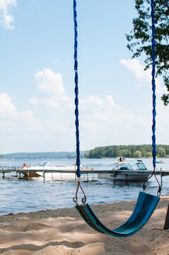 empty swing near a lake