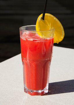 glass of fresh strawberry juice with lemon slice