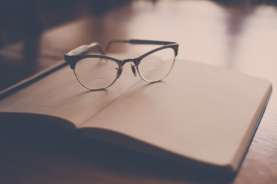 vintage glasses resting on book