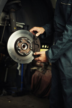 Mechanic fixing brakes.
