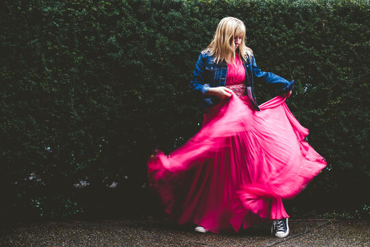 Woman in a pink gown runs free.