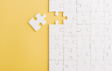 Top view flat lay of paper plain white jigsaw puzzle game texture last pieces for solve and place,...