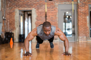 Muscular African-American man doing push-ups