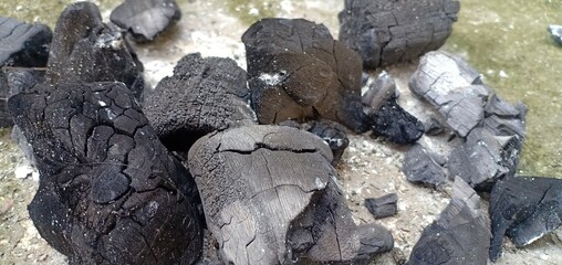 Lump of black charcoal on the cement floor in Thailand at country.