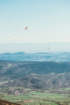 man practicing paragliding on the mountains