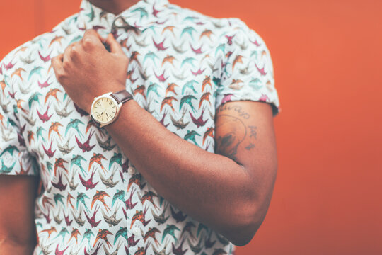 Cropped view of modern young black man in front a orange wall.
