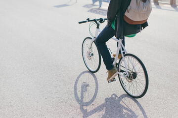 Man riding bike cycle over a boulevard along the beach on a sunny day.