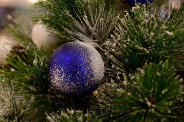 Closeup of Christmas Ball on Christmas Tree with bokeh beautiful background for design and decoration, new year concept, selective focus.