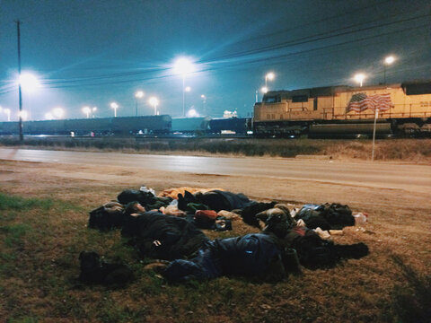 People Sleeping by Train Yard