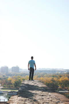 Back view of a man standing on edge