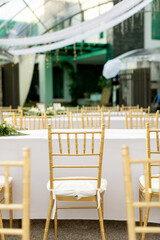 wedding dining table setup using gold chiavari chair