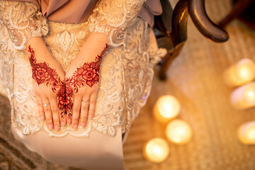 a bride put on henna on her hand on her wedding day