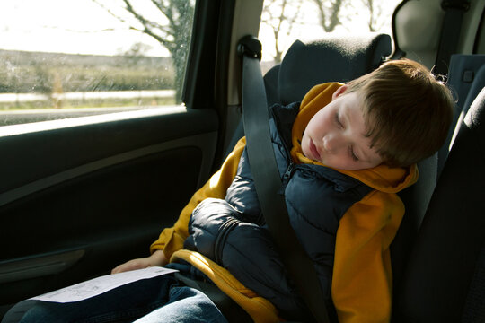 Boy asleep in car backseat