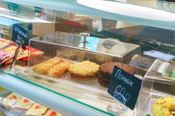 Showcase with desserts in coffee shop close up