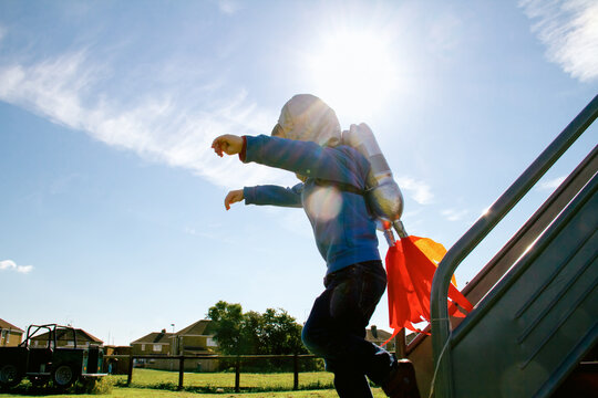 Boy jumps wearing homemade rocket pack costume