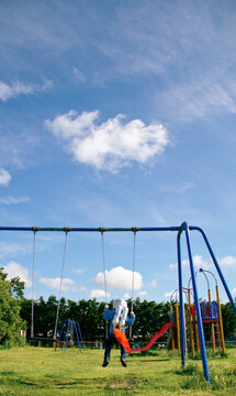 Boy with homemade rocket pack on a swing