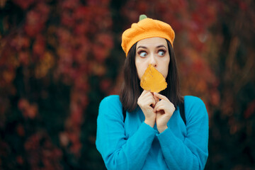 Funny Woman with Autumn Leaf Looking Sideways