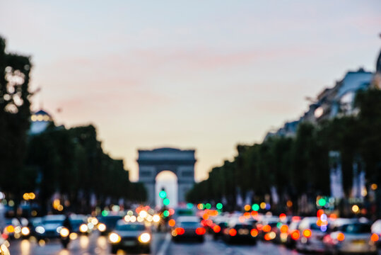 Traffic at Arc De Triomphe in Paris at twilight