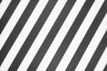 Fragment of a striped wrinkled black and white piece of a cloth fabric as a background texture