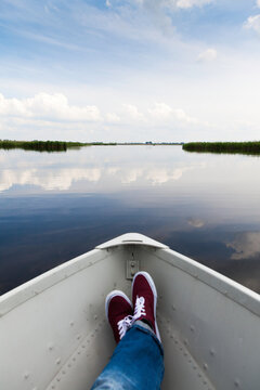 Reflection of clouds in the water, as seen someone lying in a small boat