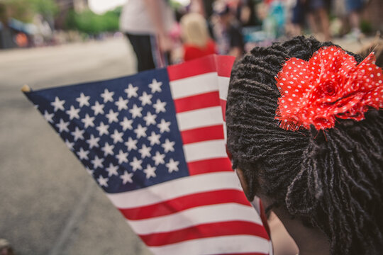 African-American Girl Waiving a USA Flag at a National Day Parade
