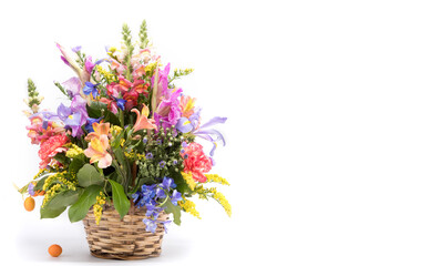bouquet of bright flowers in basket isolated on white background.Copy Space. . Mothers Day or Valentines Day Concept