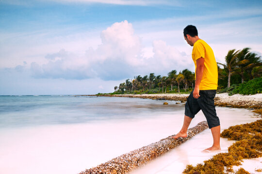 Young man holding a log