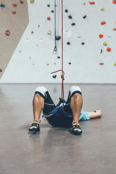 exhausted climber laying on the floor after a hardcore climbing session