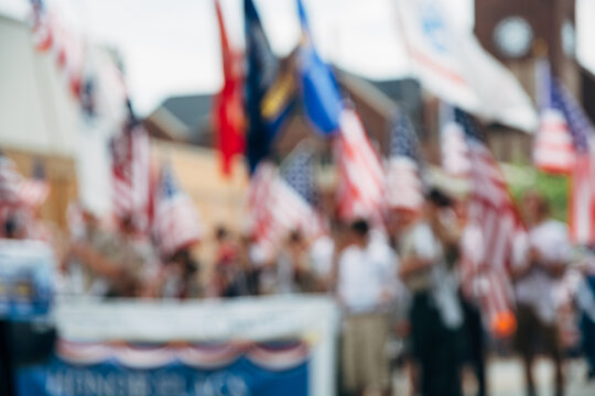 Marching Group of People Holding USA Flags at a National Day Parade