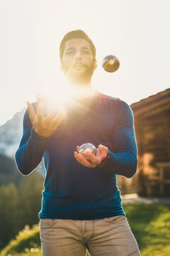 portrait of a young man juggling boccia balls