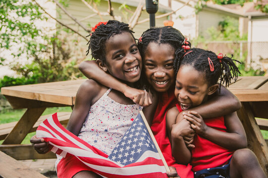 Three African-American Girls in Red, White and Blue USA Flag Outfits Laughing