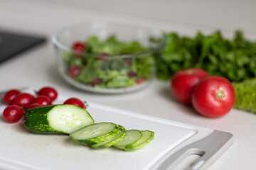 Healthy vegetarian dish on table, vegetable salad with fresh tomato, cucumber, lettuce. Diet menu.