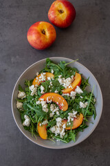 healthy arugula salad with peach and feta cheese