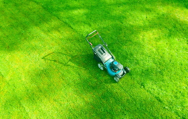 Aerial mowing lawns. Top aerial view lawn mower on green grass. Mower grass equipment. Mowing...