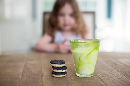 Cute toddler eagerly awaiting cookies and milk