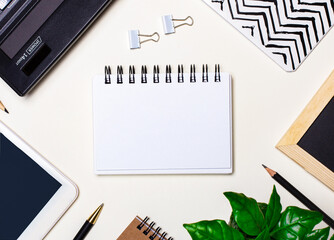 Business accessories and a blank notebook lie on a white background. Flat lay. Copy space