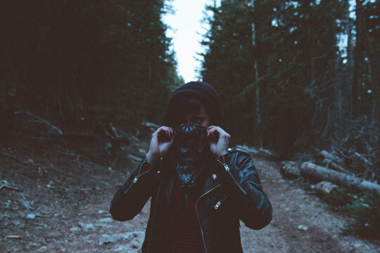 Young woman wearing mask in woods