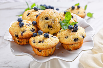 Blueberry muffins on a white cake stand, close-up