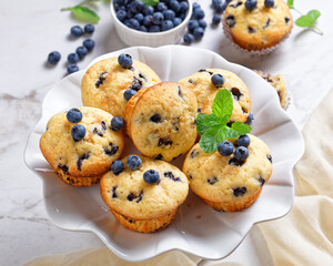 Blueberry muffins on a white cake stand, close-up
