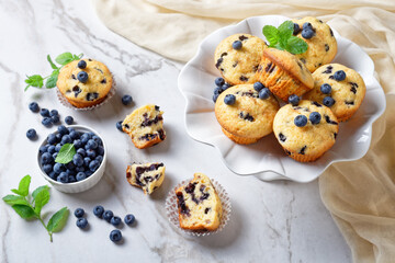 Blueberry muffins on a white cake stand, close-up