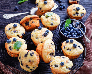 Blueberry muffins on a rustic wooden background