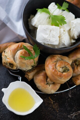 Close-up of greek mini spiral pies made of filo dough, spinach and feta cheese, vertical shot, selective focus